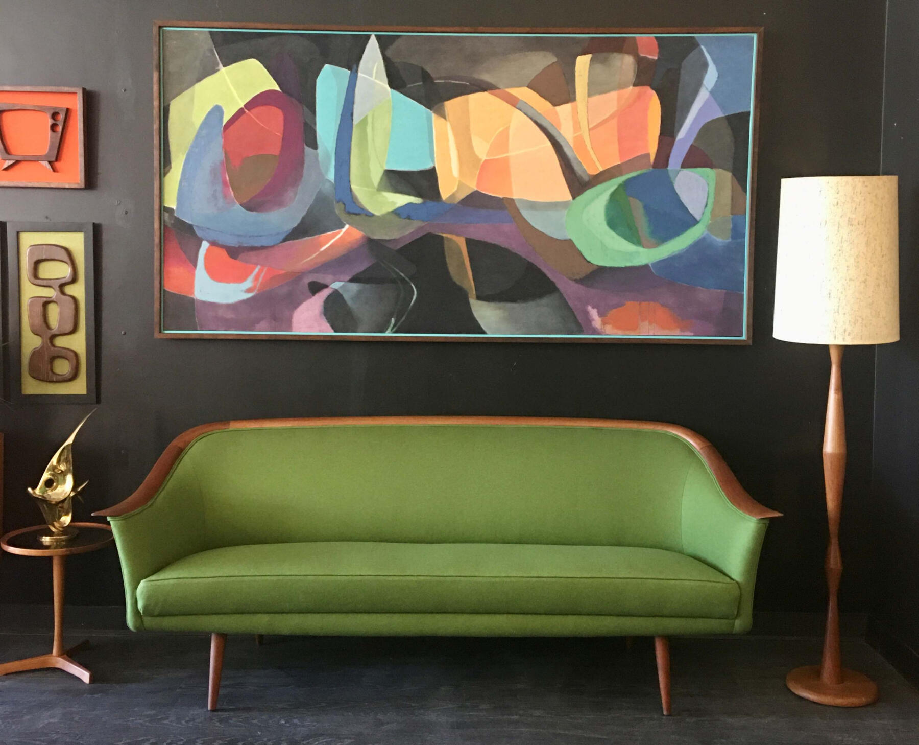 Mid‑century modern green upholstered sofa with wooden frame. Trusted mid-century buyers Mr. Mansifled Vintage Calgary